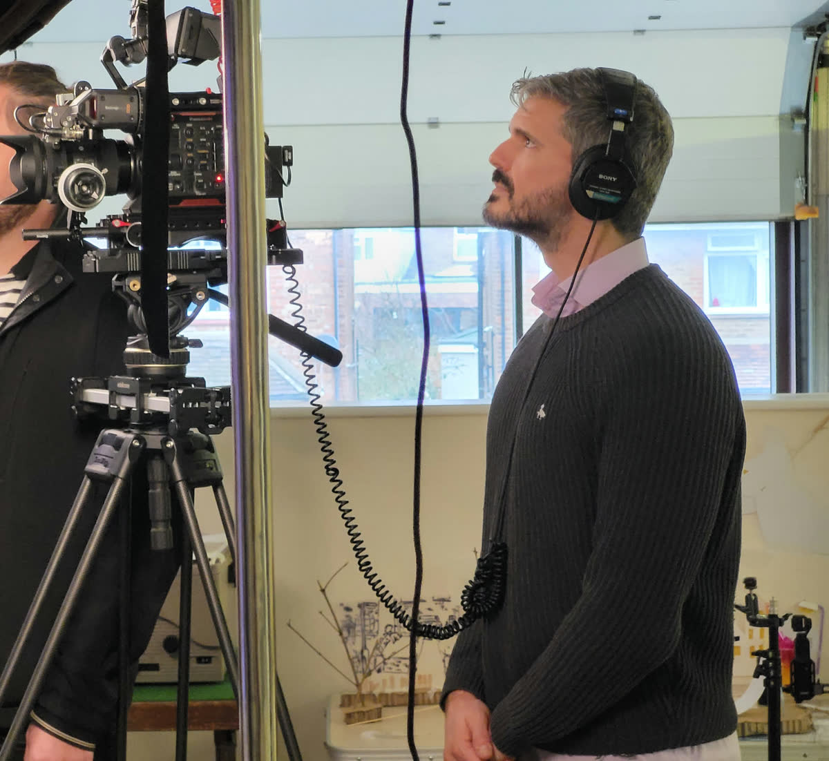 Eduardo Benfatti wearing headphones on a film set