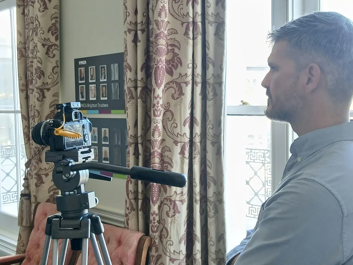 Eduardo lining up an interview shot at YMCA Brighton